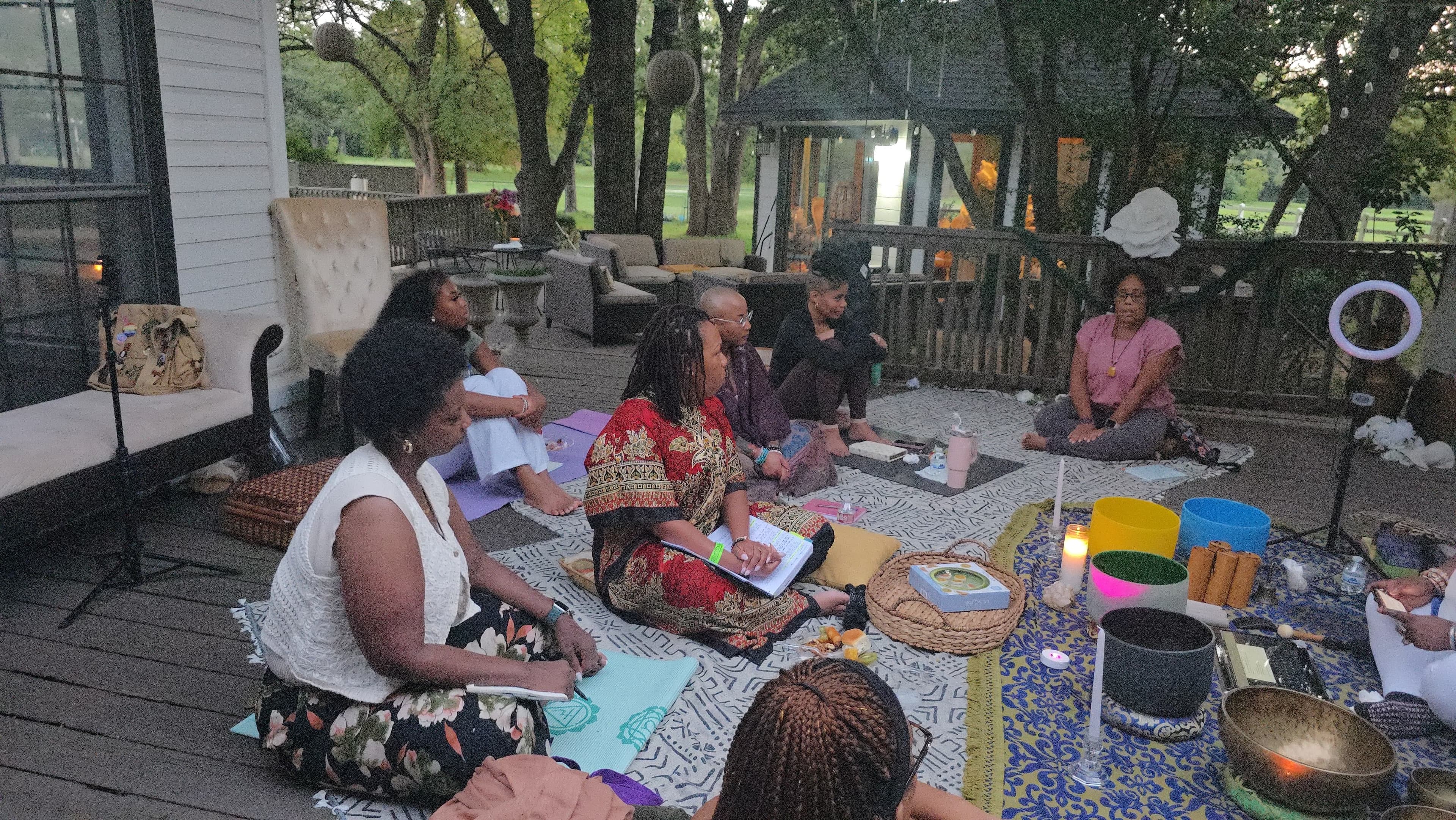 Goddess Mariposa leading a group sound healing circle outdoors